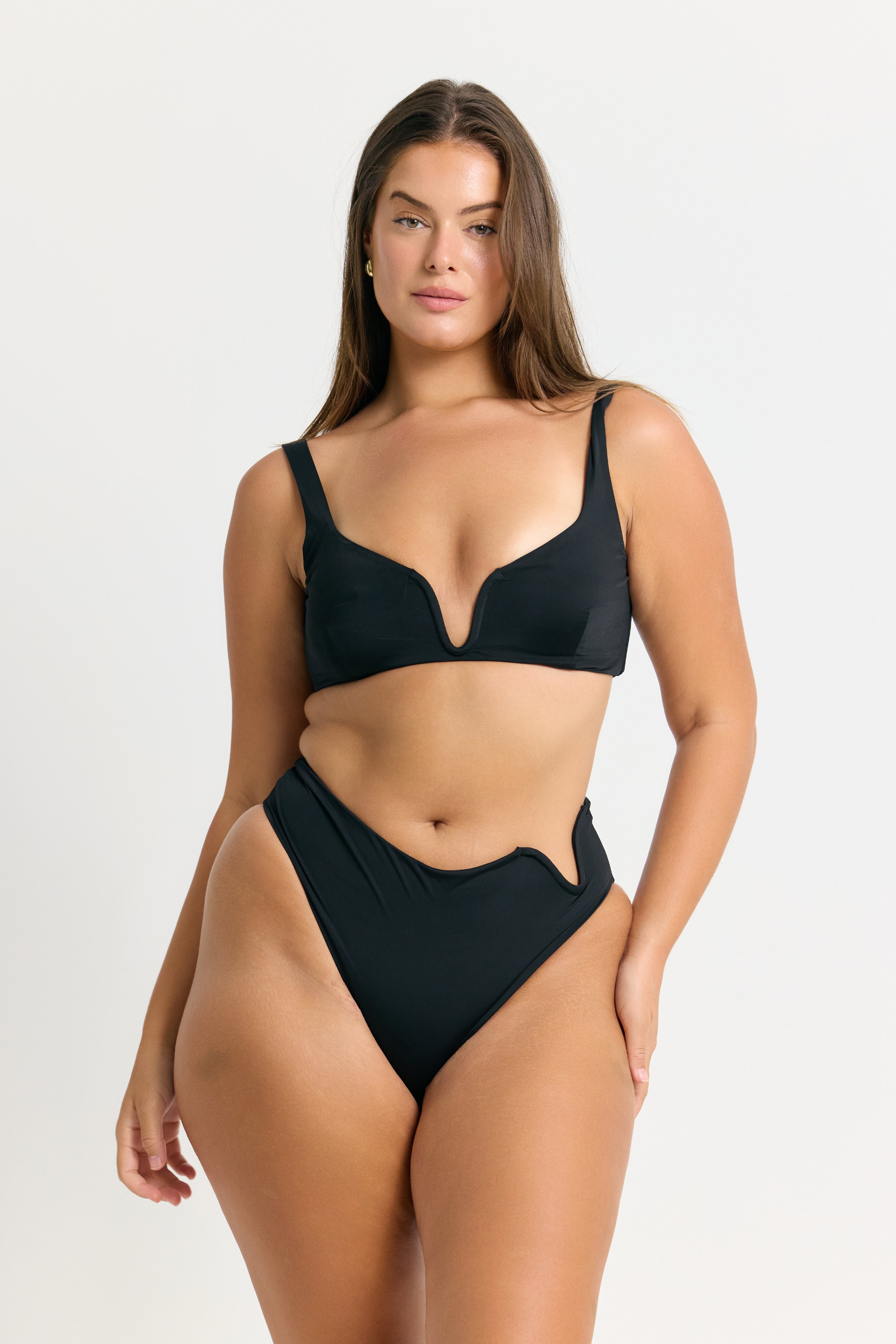 Woman wearing a black bikini on a white background
