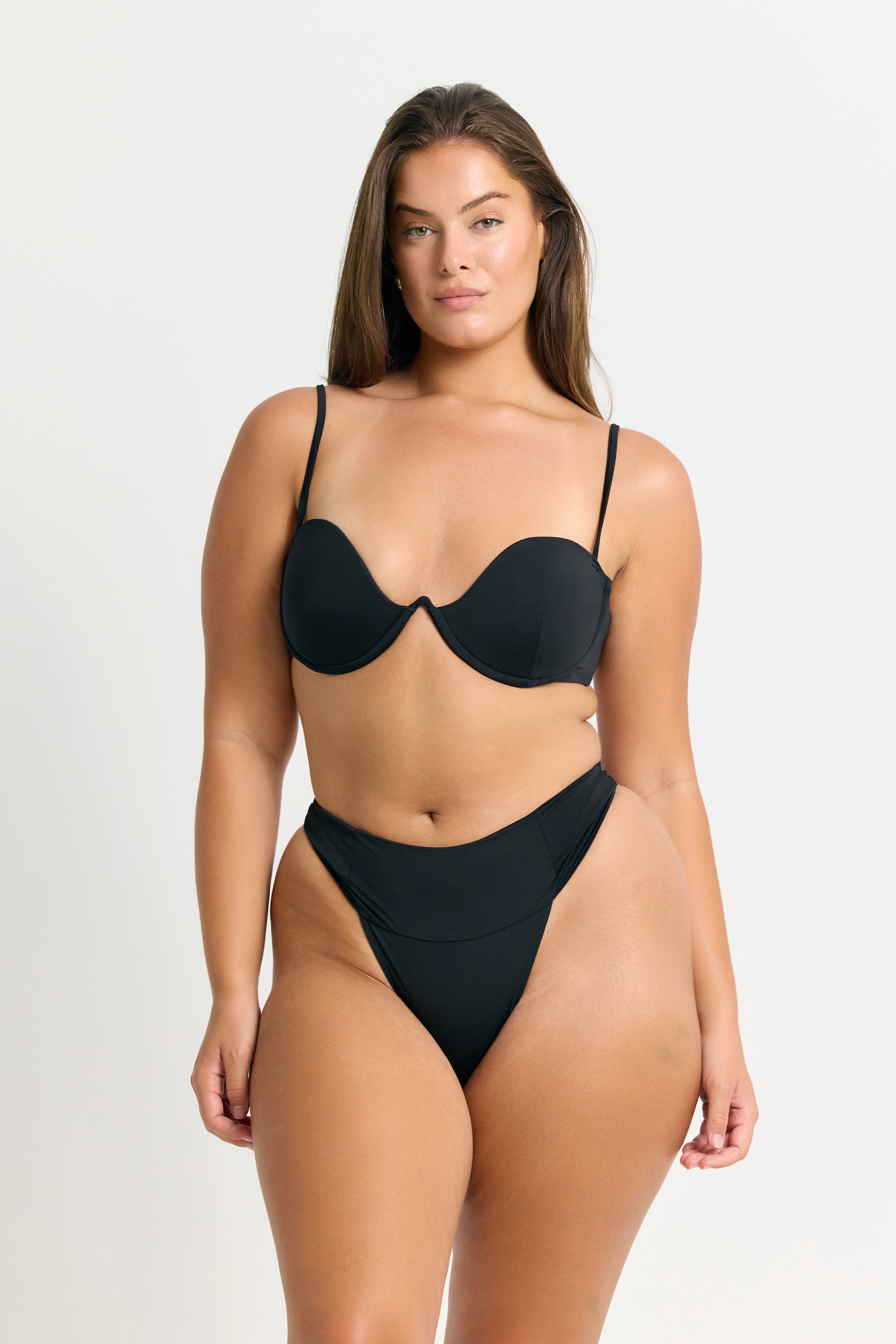 Woman wearing a black bikini on a white background