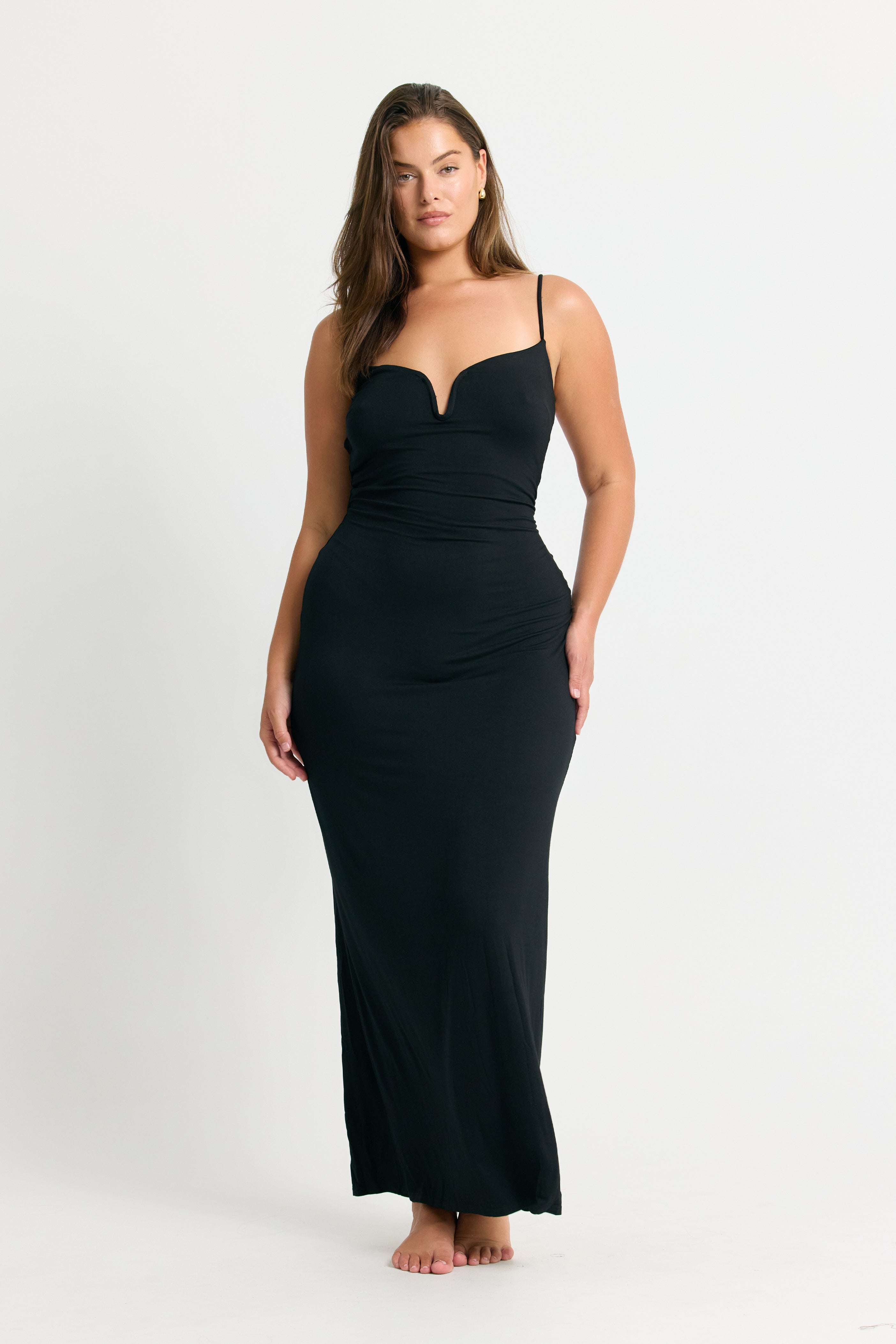 Woman wearing a black evening gown on a white background