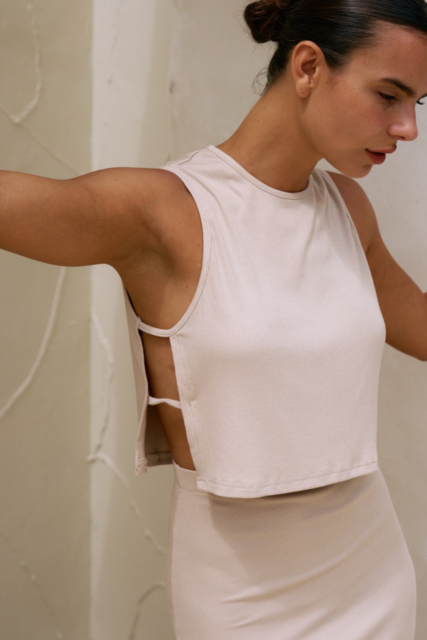 Close-up side detail of the Simi Top in Coconut showing side ties and rib texture.