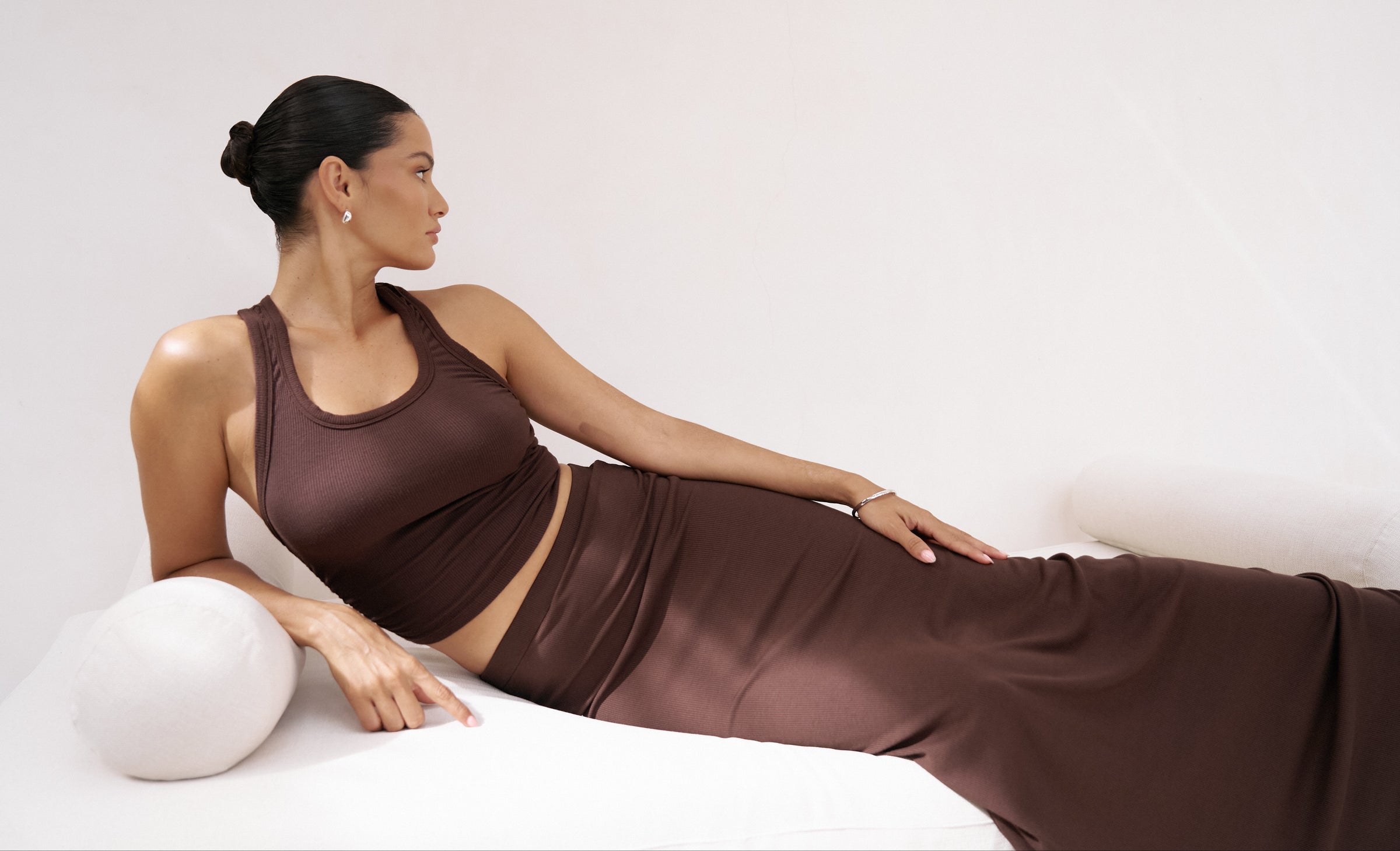 Model in a brown tank top and brown maxi skirt.