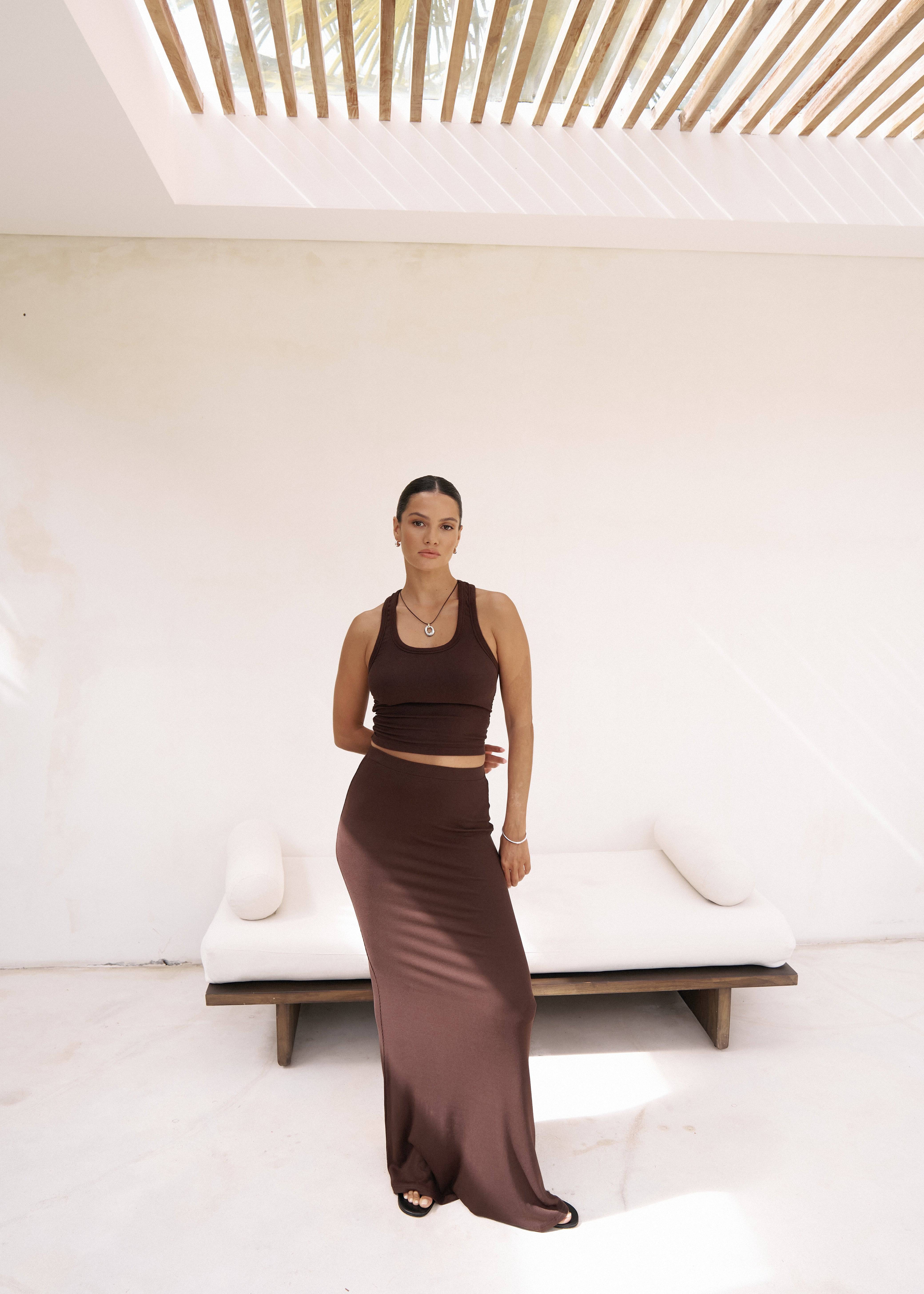 Riot Lounge Dom Racerback Tank in chocolate color, styled with a maxi skirt, casual sleeveless top for women.