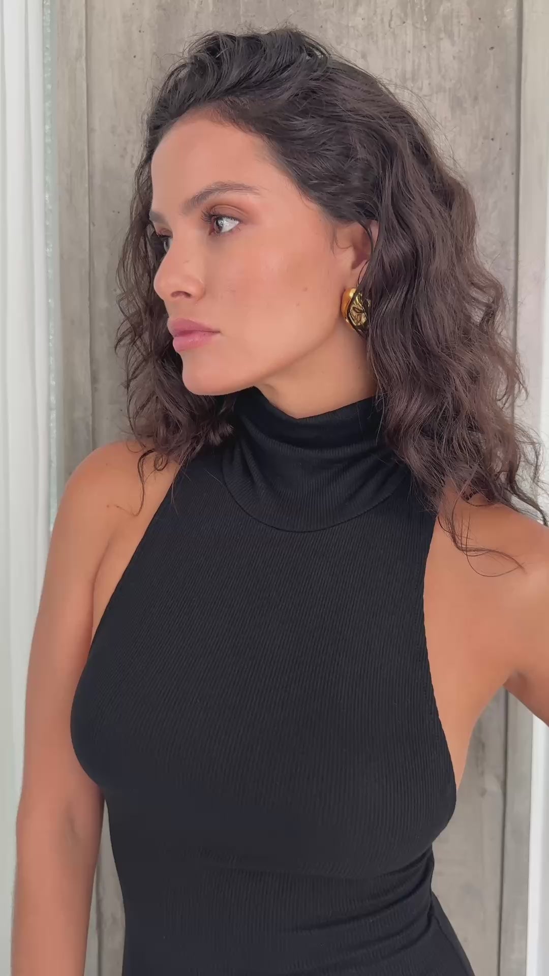 Model wearing Riot black maxi dress.