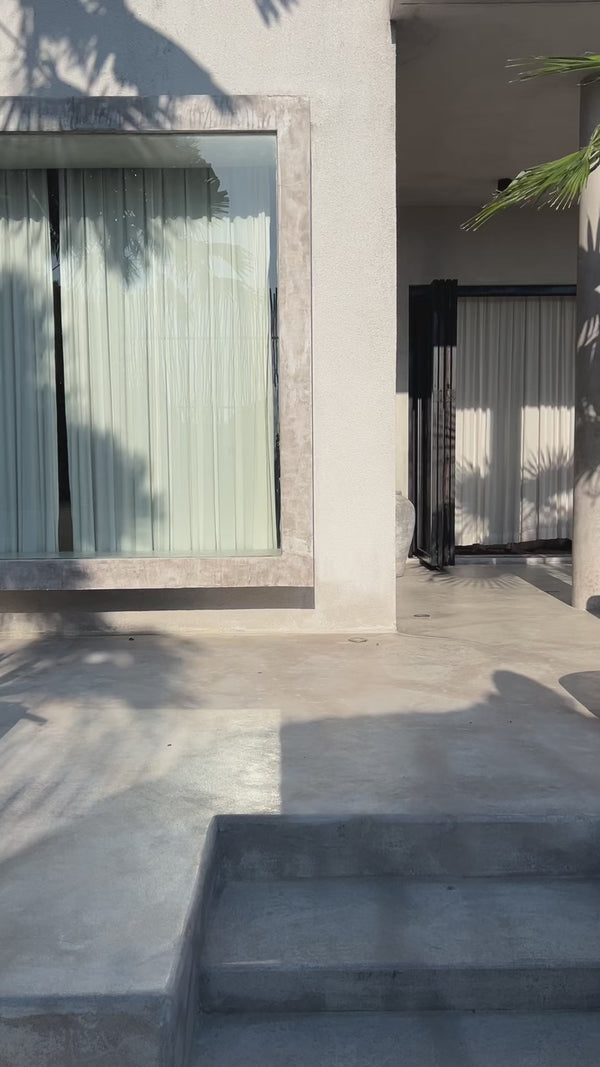 Woman walking in the RIOT Hendrix maxi dress in Coconut outdoors.