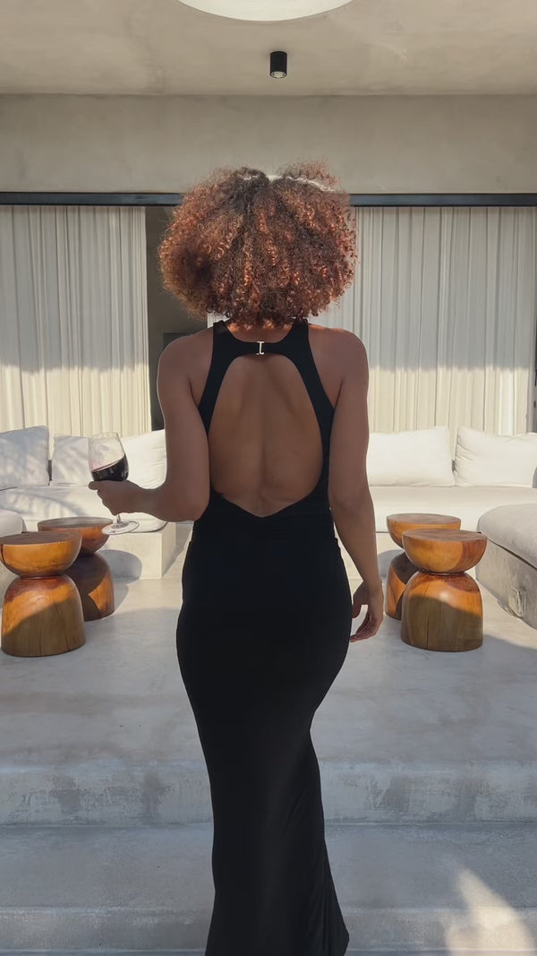 Back view of the RIOT Remi maxi dress in Black, showing its open-back neckline.