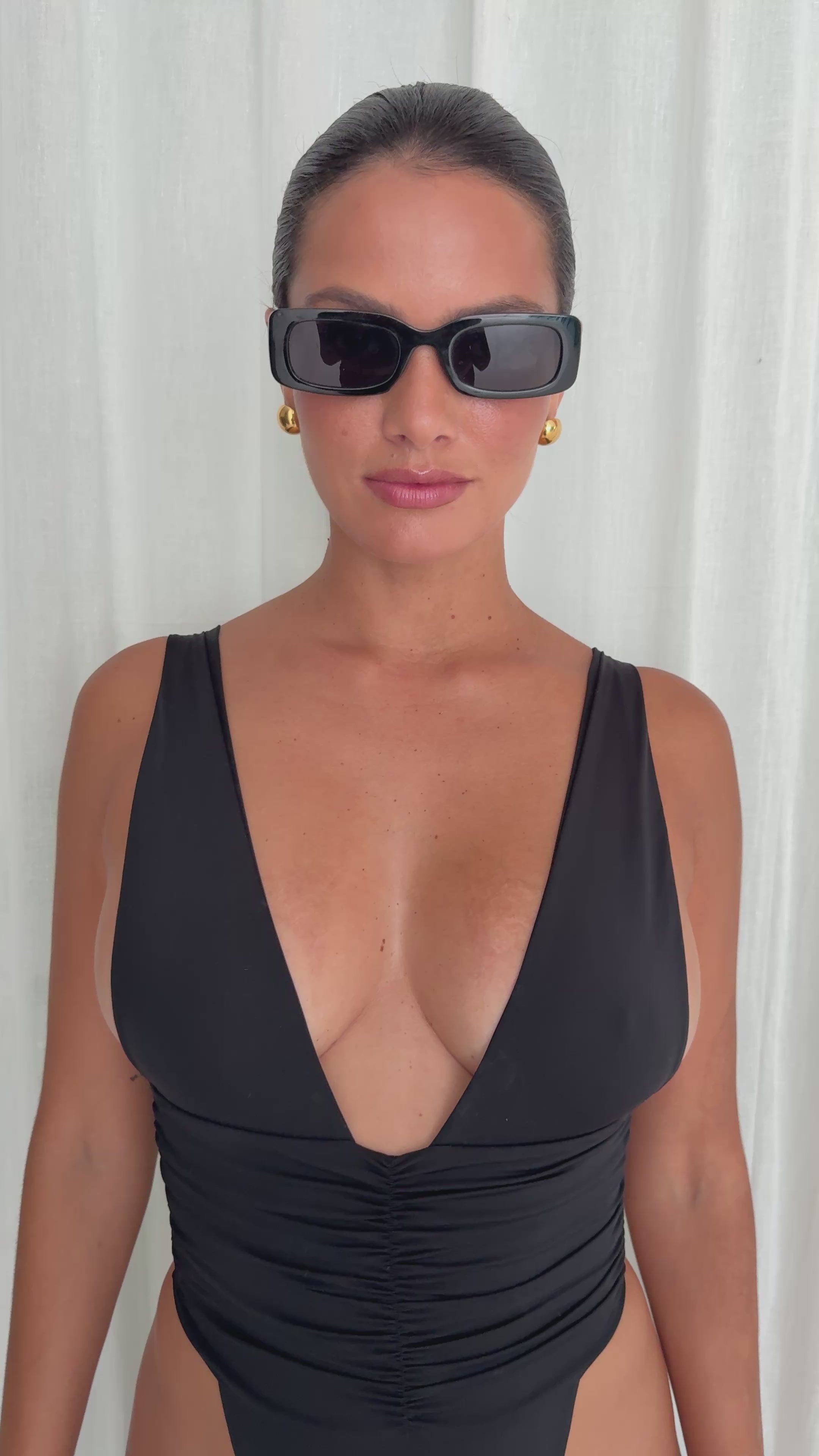 Model wearing the RIOT Echo One Piece Minimal in Black, showing its fit and styling.